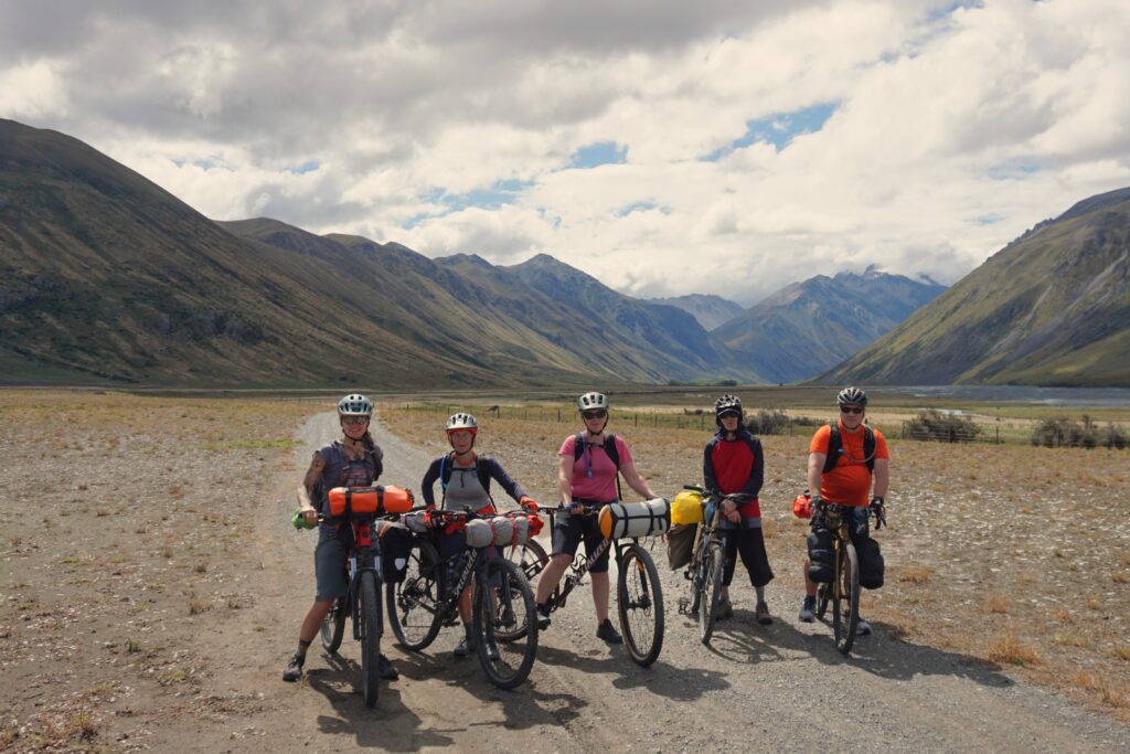 a group of bikepackers of all ages in new zealand