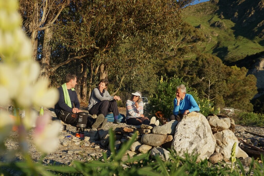 a happy group of bikepackers around camp