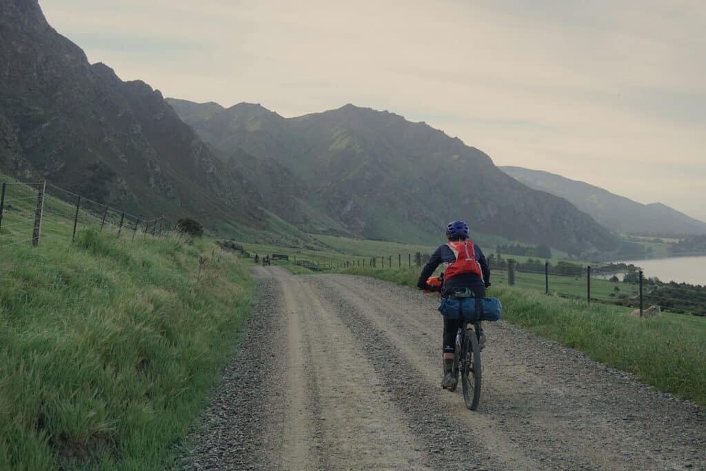 tegan riding gravel road on bikepacking course