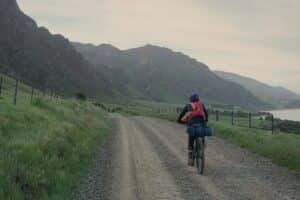 tegan riding gravel road on bikepacking course