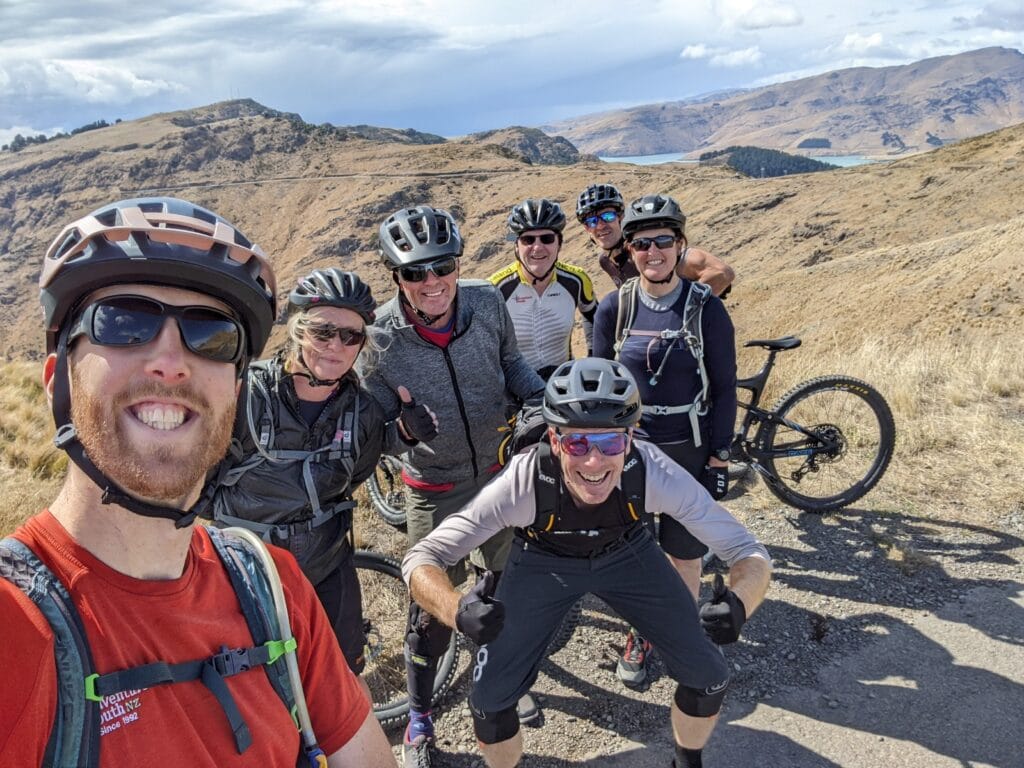 group of smiling mountain bikers on mtb trip