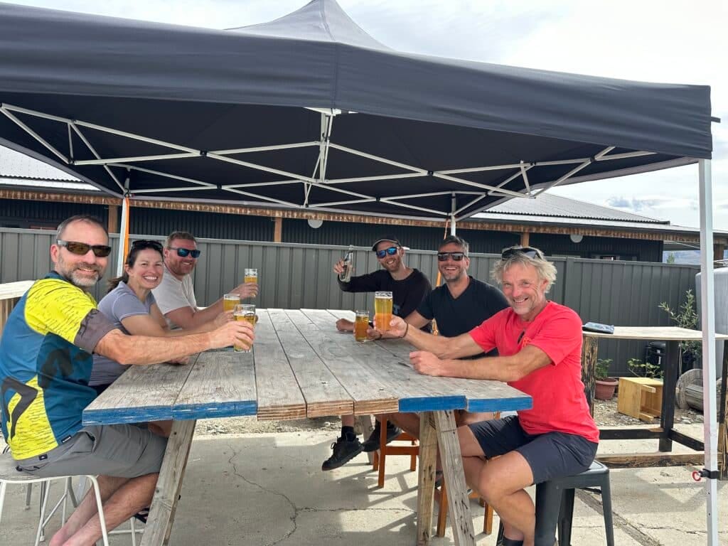 mountain bike riders enjoying beers at the end of a tour