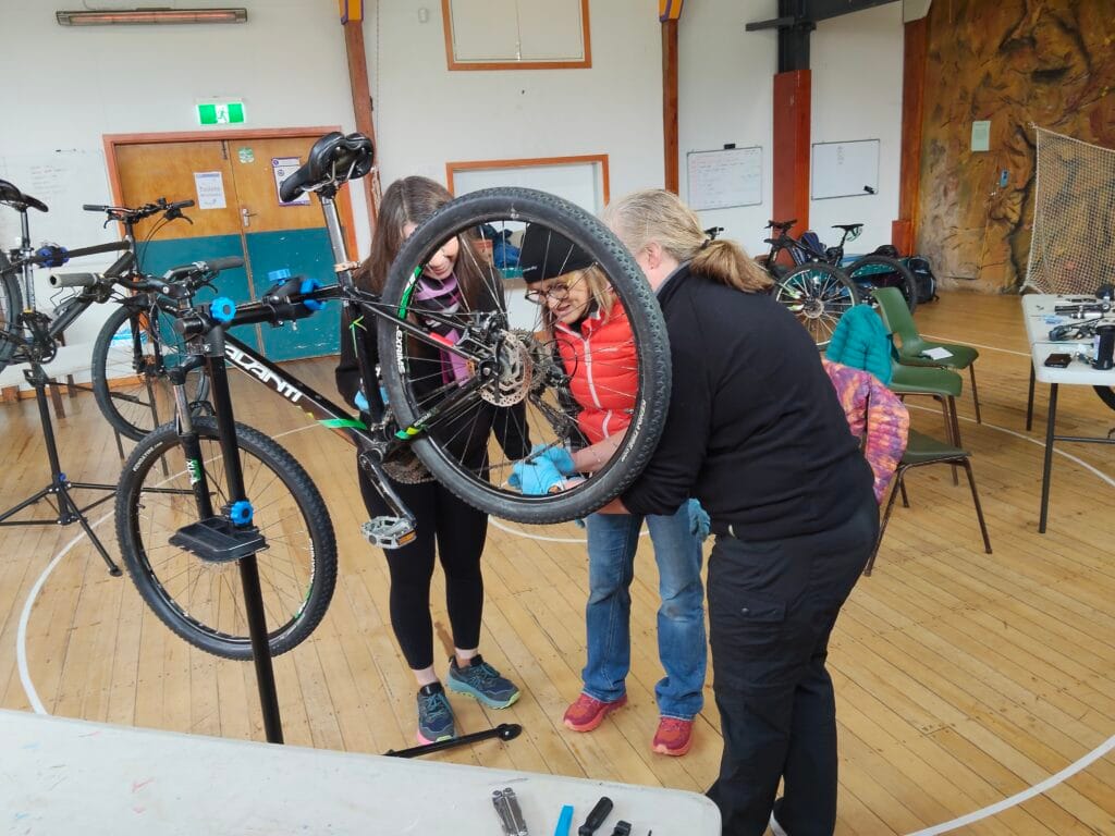 people doing bike mechanics on course