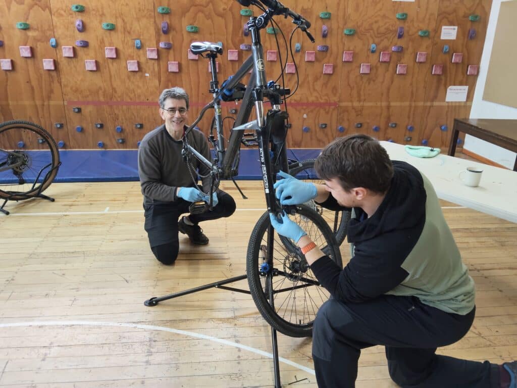 2 men on bike mechanics course in christchurch
